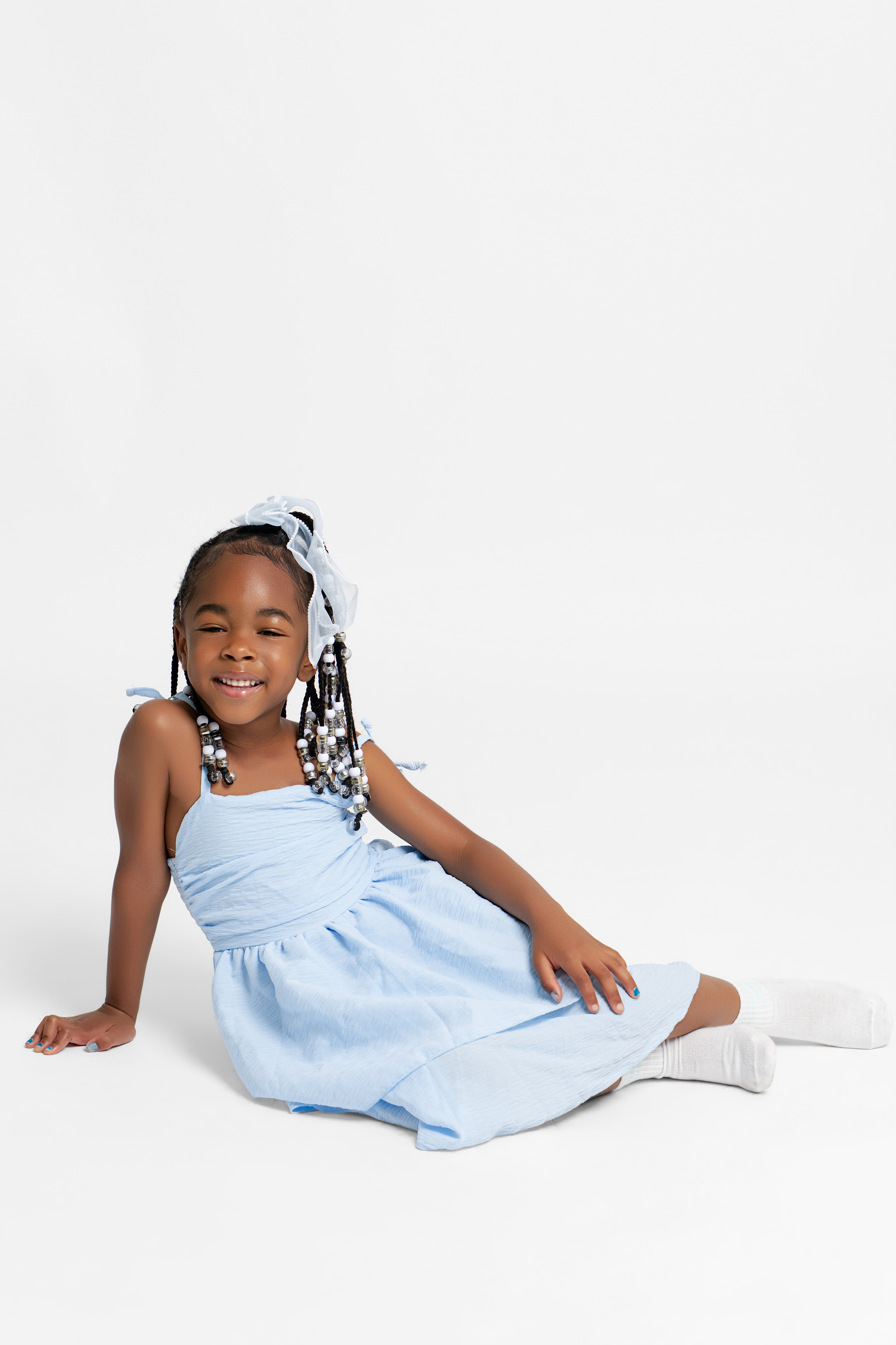 Young girl posing on a white backdrop during a self portrait studio session in Queens NYC